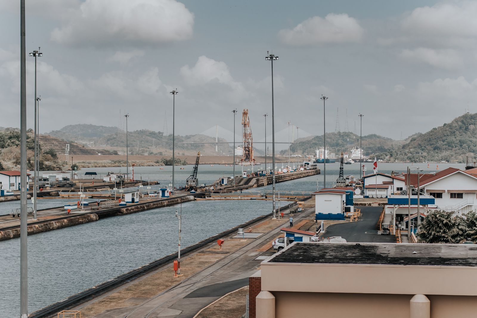 Panama Canal locks and the surrounding green landscape in daylight, the highlight of Panama Canal repositioning cruises